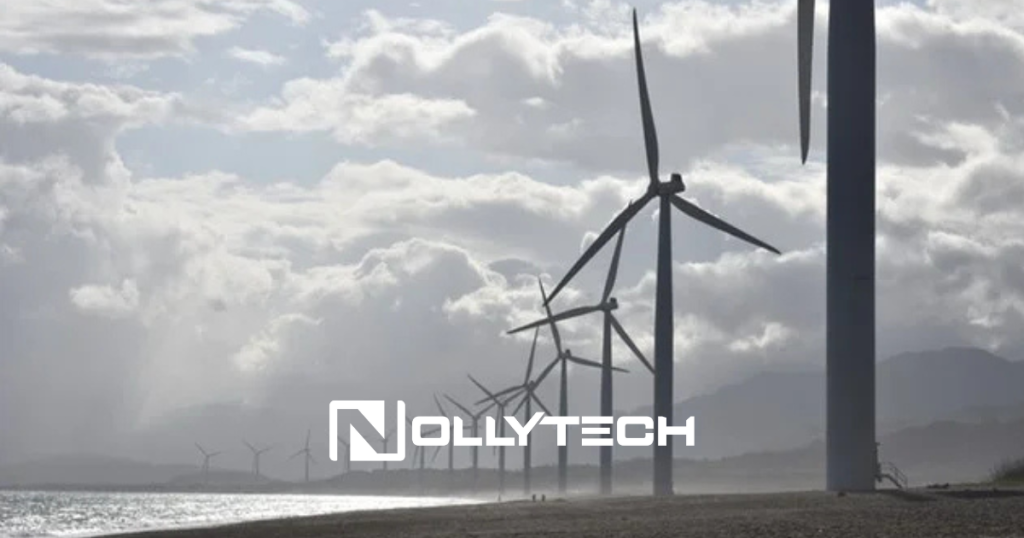A row of wind turbines lines the beach, set against a backdrop of dramatic clouds. The Nollytech logo stands prominently at the center, symbolizing the balance between the advantages and disadvantages of wind energy. Mountains tower majestically in the background.
