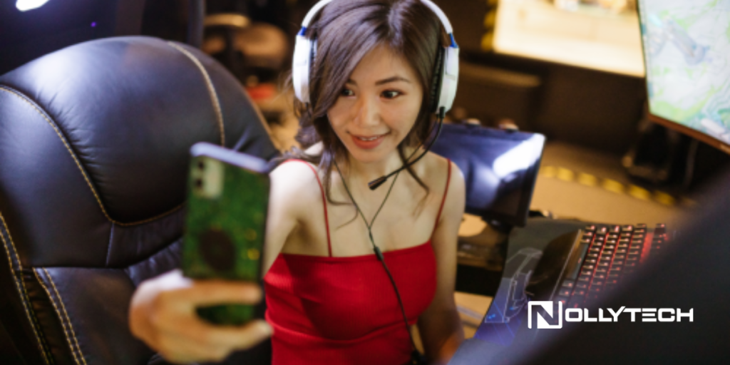 A young woman wearing a headset and red dress takes a selfie while sitting in a gaming chair at her computer setup, showing she's dedicated to Improving Your Live Streams. The word NOLLYTECH appears in the bottom right corner.